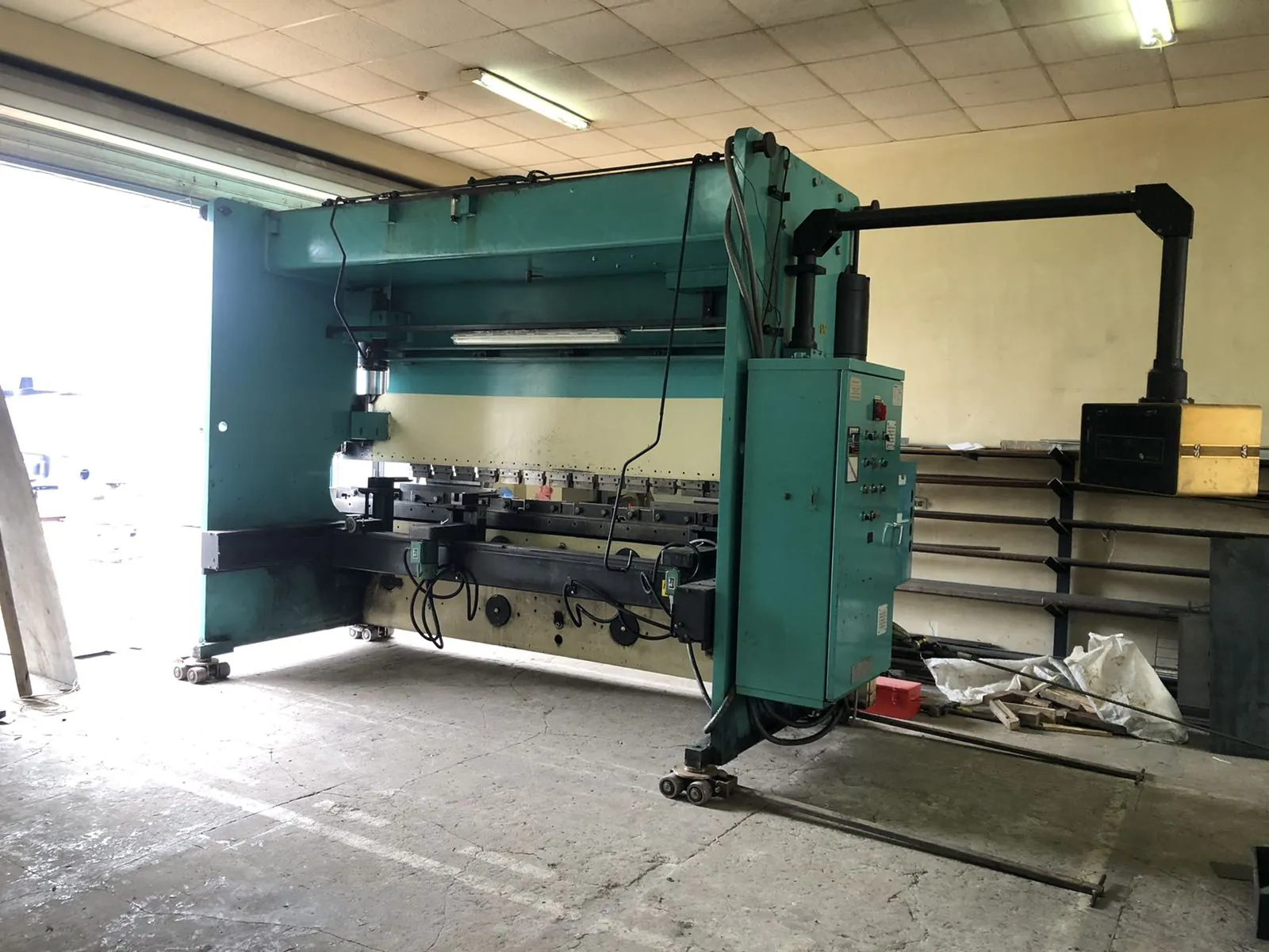Press brake on machinery skates inside a fabrication shop
